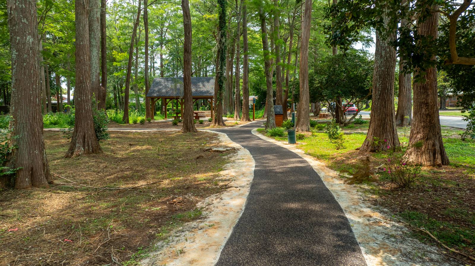 Flexus AP-200 installed — permeable trail curving past the pavilion, Azalea Park